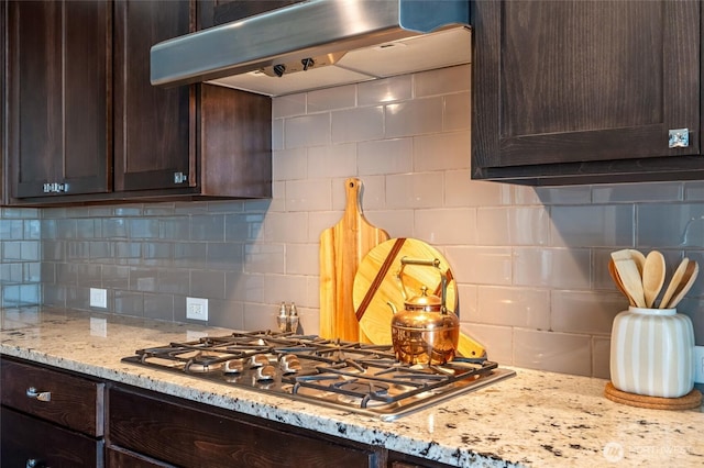 619 Graham Ave NE, Renton, WA 98059 - kitchen featuring extractor fan, dark brown cabinets, stainless steel gas cooktop, backsplash, and light stone countertops