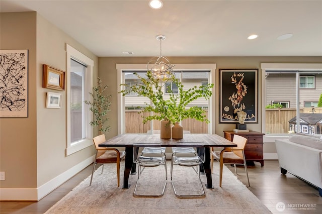 619 Graham Ave NE, Renton, WA 98059 - dining room with healthy amount of natural light, wood finished floors, recessed lighting, and a chandelier
