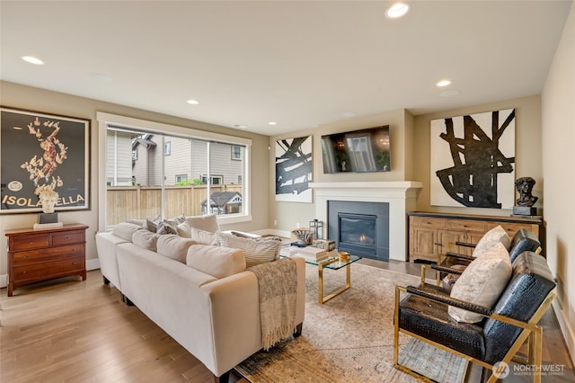 619 Graham Ave NE, Renton, WA 98059 - living area with wood finished floors, recessed lighting, and a fireplace with flush hearth