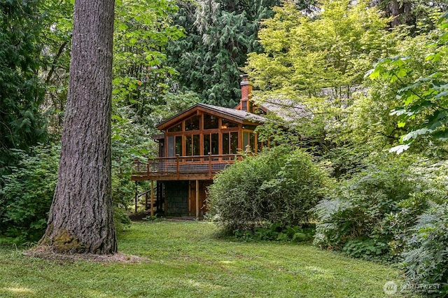 5510 Mt Baker Hwy, Deming, WA 98244 - back of house featuring a deck, a chimney, a wooded view, a yard, and a metal roof