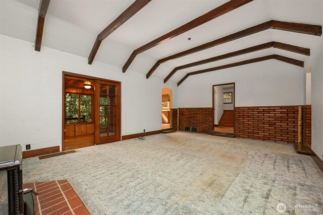 5510 Mt Baker Hwy, Deming, WA 98244 - unfurnished living room with carpet, a wainscoted wall, and arched walkways