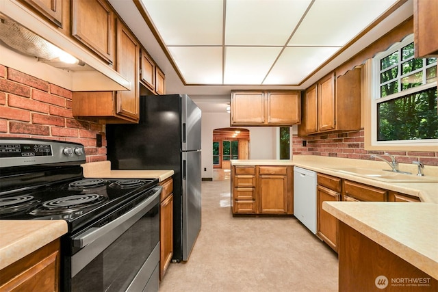 5510 Mt Baker Hwy, Deming, WA 98244 - kitchen with stainless steel range with electric stovetop, under cabinet range hood, dishwasher, light countertops, and brown cabinets