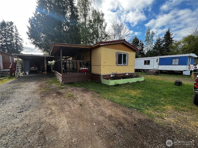38 Hurd Rd Unit 34, Elma, WA 98541 - manufactured / mobile home featuring dirt driveway, a front yard, and an attached carport