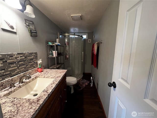 38 Hurd Rd Unit 34, Elma, WA 98541 - full bath featuring wood finished floors, a stall shower, vanity, and tasteful backsplash