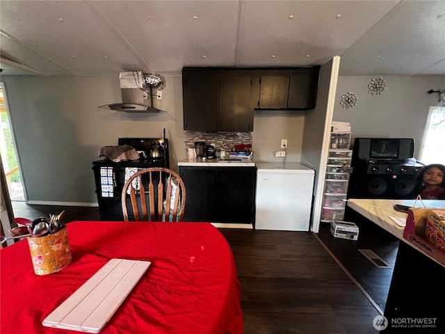 38 Hurd Rd Unit 34, Elma, WA 98541 - kitchen with wall chimney exhaust hood, range, dark wood finished floors, light countertops, and white refrigerator