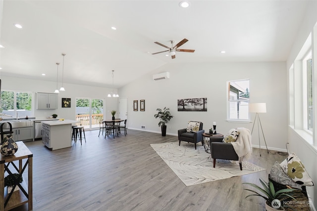 13540 Carney Lake Rd SW, Port Orchard, WA 98367 - living area featuring a wall mounted air conditioner, wood finished floors, vaulted ceiling, recessed lighting, and ceiling fan