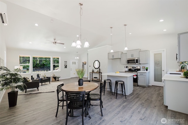 13540 Carney Lake Rd SW, Port Orchard, WA 98367 - dining area featuring light wood finished floors, lofted ceiling, recessed lighting, a chandelier, and a ceiling fan