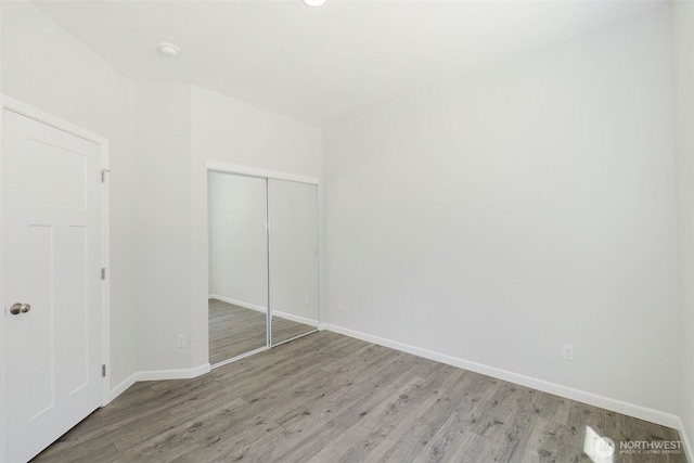 13540 Carney Lake Rd SW, Port Orchard, WA 98367 - unfurnished bedroom with light wood-style floors and a closet