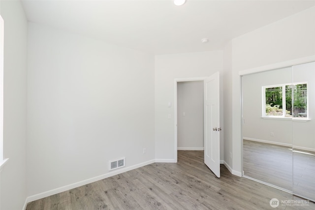 13540 Carney Lake Rd SW, Port Orchard, WA 98367 - unfurnished bedroom with light wood-style floors and baseboards