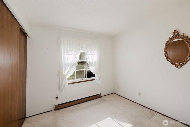 30026 5th Ave SW, Federal Way, WA 98023 - unfurnished bedroom featuring baseboard heating, a closet, and carpet floors