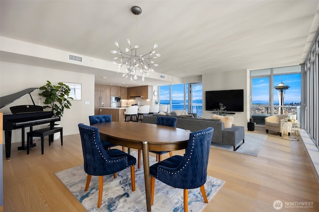 583 Battery St Unit 3802, Seattle, WA 98121 - dining room with a chandelier and light wood-type flooring