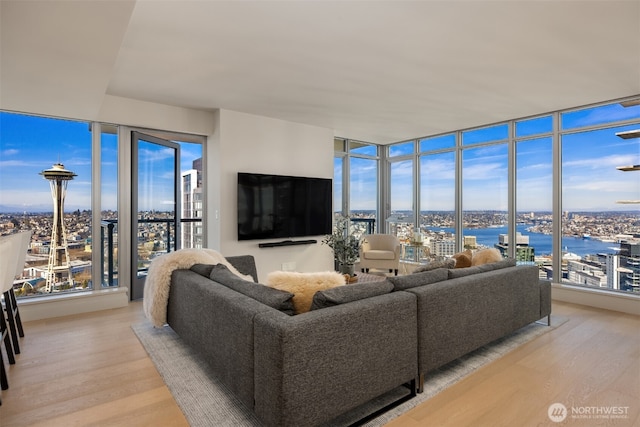 583 Battery St Unit 3802, Seattle, WA 98121 - living room with light wood-style floors, healthy amount of natural light, and a wall of windows