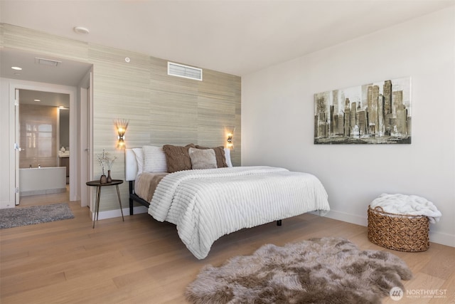 583 Battery St Unit 3802, Seattle, WA 98121 - bedroom featuring wood finished floors and an accent wall