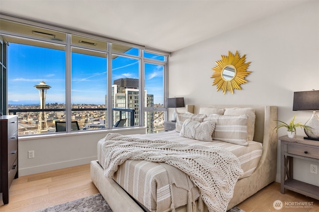 583 Battery St Unit 3802, Seattle, WA 98121 - bedroom with wood finished floors and a view of city