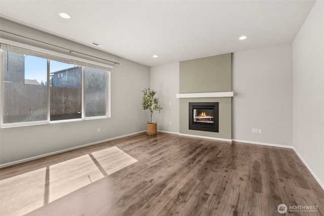 2846 Anna St NE, Lacey, WA 98516 - unfurnished living room with wood finished floors, a glass covered fireplace, and recessed lighting