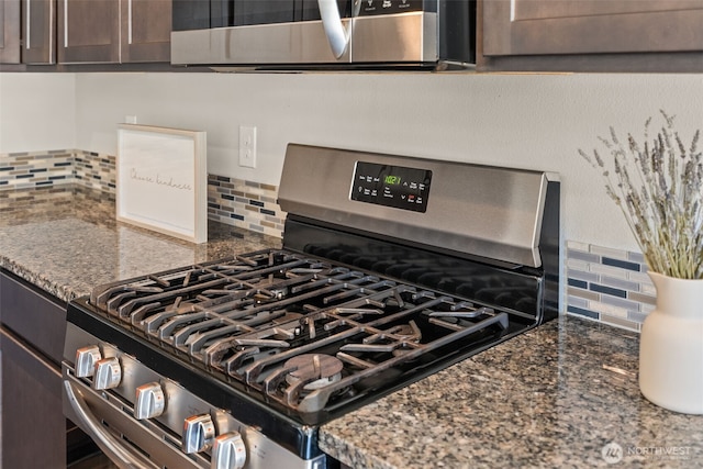 2846 Anna St NE, Lacey, WA 98516 - kitchen view of stainless steel gas range oven, backsplash, dark brown cabinets, and dark stone countertops