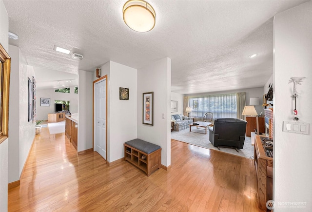 527 Fern Rd, Bellingham, WA 98225 - corridor featuring a textured ceiling and light wood-style floors