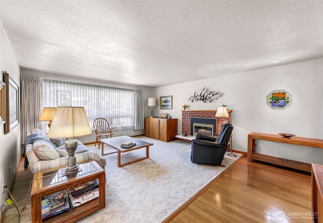 527 Fern Rd, Bellingham, WA 98225 - living room with a textured ceiling, wood finished floors, and a fireplace