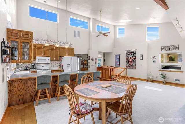 527 Fern Rd, Bellingham, WA 98225 - dining room featuring a high ceiling, light wood-style floors, and a ceiling fan