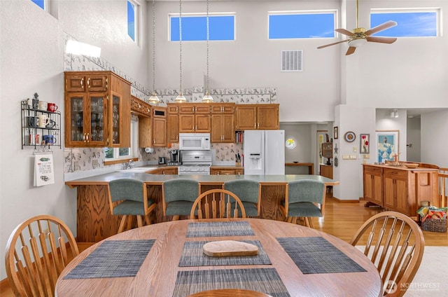 527 Fern Rd, Bellingham, WA 98225 - dining space featuring a towering ceiling, light wood finished floors, and a ceiling fan