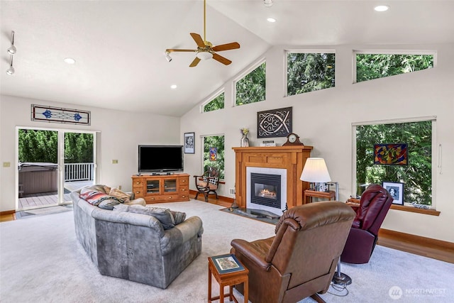 527 Fern Rd, Bellingham, WA 98225 - living room featuring high vaulted ceiling, plenty of natural light, a ceiling fan, a fireplace with flush hearth, and recessed lighting