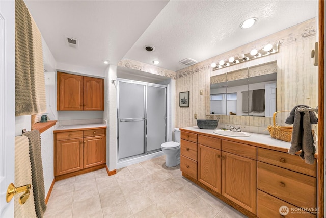 527 Fern Rd, Bellingham, WA 98225 - bathroom featuring vanity, a shower stall, wallpapered walls, a textured ceiling, and tile patterned flooring