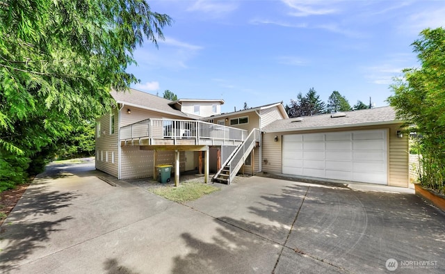 527 Fern Rd, Bellingham, WA 98225 - view of front of house featuring stairway, a garage, a wooden deck, and driveway