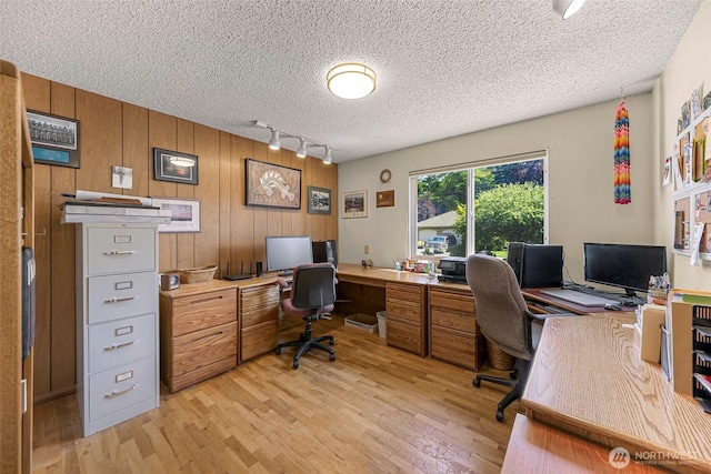 527 Fern Rd, Bellingham, WA 98225 - office with track lighting, light wood-type flooring, a textured ceiling, and wood walls