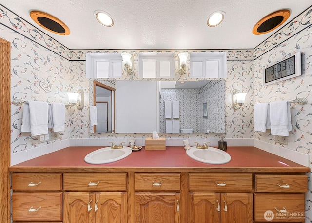 527 Fern Rd, Bellingham, WA 98225 - bathroom with wallpapered walls, double vanity, and a textured ceiling