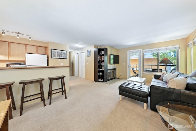 29 Etruria St Unit B405, Seattle, WA 98109 - living room featuring light carpet and a fireplace with flush hearth