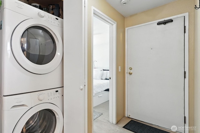 29 Etruria St Unit B405, Seattle, WA 98109 - laundry room featuring estacked washer and dryer and light colored carpet