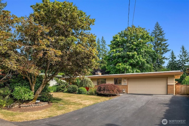16223 NE 26th St, Bellevue, WA 98008 - view of front facade featuring brick siding, asphalt driveway, an attached garage, and a front yard
