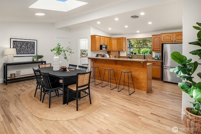 16223 NE 26th St, Bellevue, WA 98008 - dining room with a skylight, lofted ceiling, recessed lighting, and light wood-style floors
