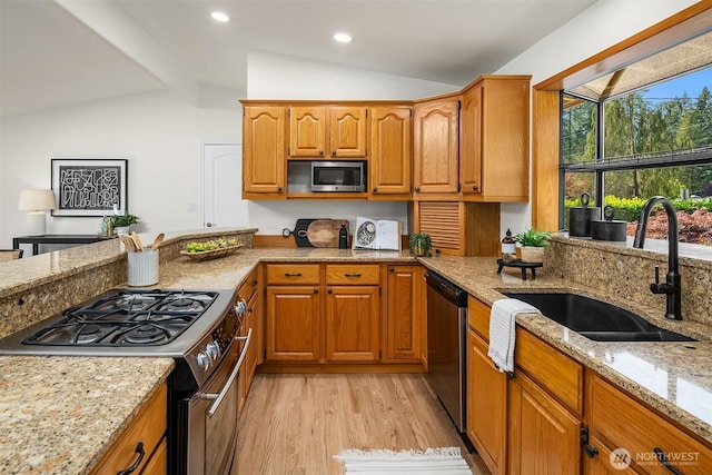 16223 NE 26th St, Bellevue, WA 98008 - kitchen with appliances with stainless steel finishes, light stone counters, light wood-style floors, brown cabinetry, and recessed lighting