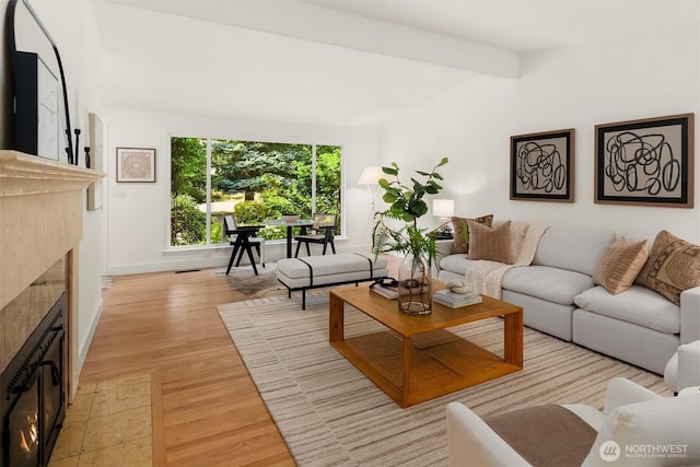 16223 NE 26th St, Bellevue, WA 98008 - living area with a tile fireplace, light wood-style flooring, and beam ceiling