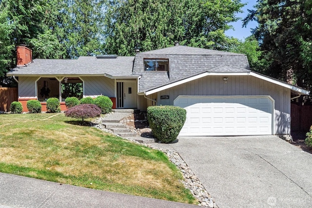 17726 NE 26th St, Redmond, WA 98052 - view of front facade featuring driveway, a garage, a chimney, and a shingled roof