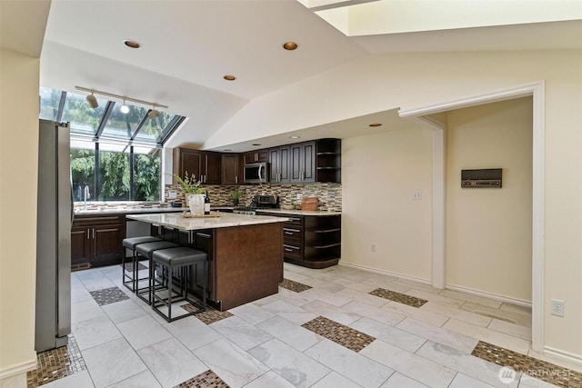 17726 NE 26th St, Redmond, WA 98052 - kitchen with appliances with stainless steel finishes, open shelves, lofted ceiling, a skylight, and a kitchen island