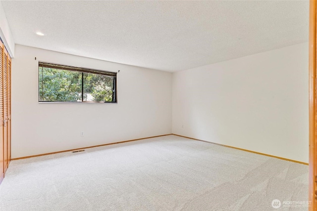 17726 NE 26th St, Redmond, WA 98052 - unfurnished bedroom with carpet flooring, a closet, a textured ceiling, and recessed lighting