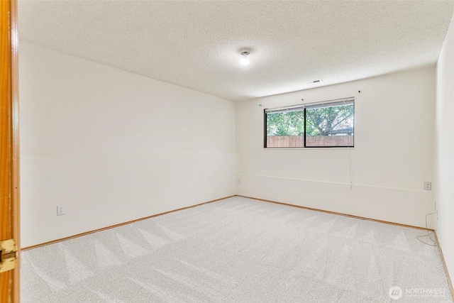 17726 NE 26th St, Redmond, WA 98052 - carpeted empty room featuring a textured ceiling and baseboards