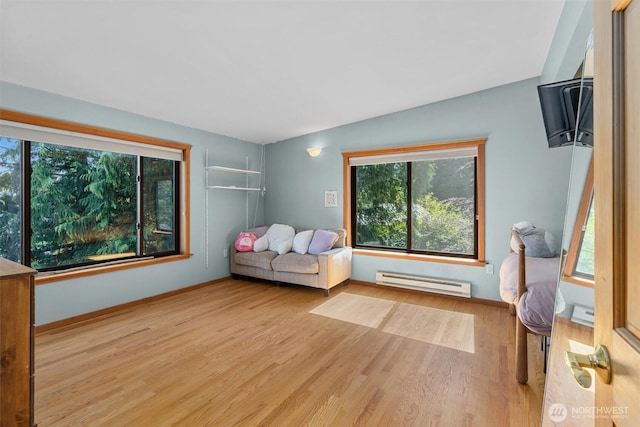 10212 SW 127th St, Vashon, WA 98070 - bedroom with baseboard heating, multiple windows, and wood finished floors