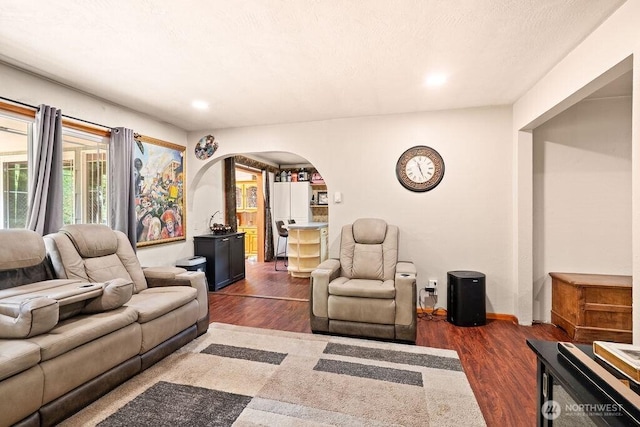 1315 Thomas St, Aberdeen, WA 98520 - living area with arched walkways, dark wood-type flooring, and recessed lighting