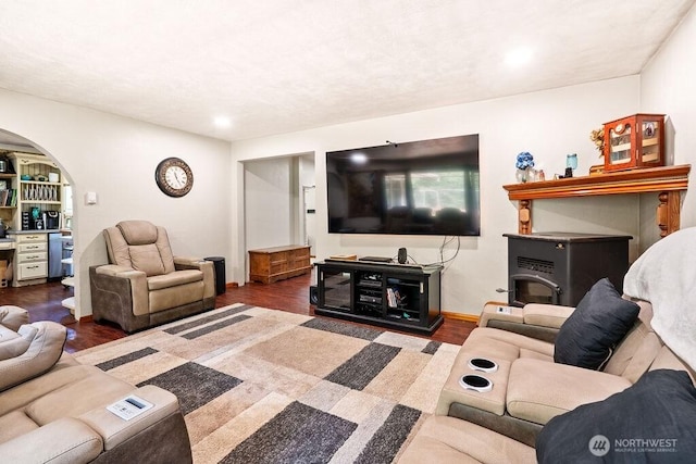 1315 Thomas St, Aberdeen, WA 98520 - living room featuring wood finished floors, arched walkways, recessed lighting, and a wood stove