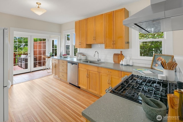 5041 Baker Ave NW, Seattle, WA 98107 - kitchen featuring dishwasher, wall chimney range hood, freestanding refrigerator, french doors, and decorative backsplash