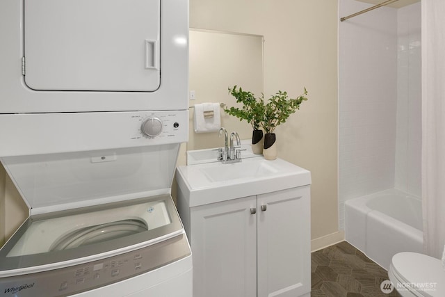 5041 Baker Ave NW, Seattle, WA 98107 - laundry room with stacked washer and clothes dryer and baseboards