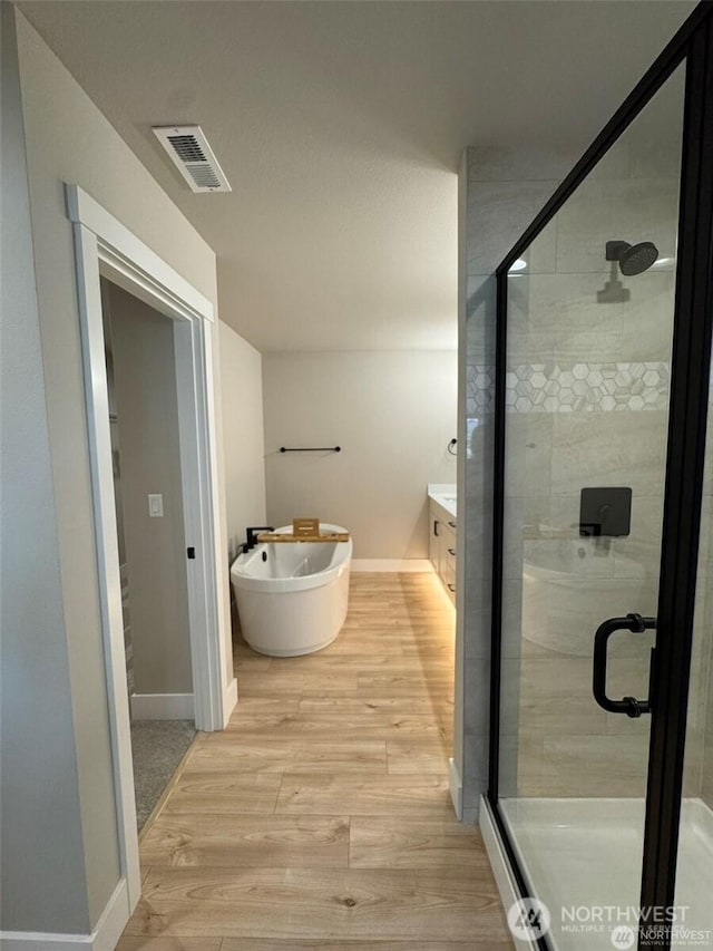 404 Trail St, Darrington, WA 98241 - full bathroom featuring wood finished floors, a stall shower, and vanity