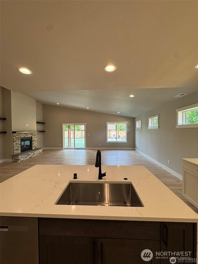 404 Trail St, Darrington, WA 98241 - kitchen with open floor plan, light wood-style flooring, light stone countertops, recessed lighting, and a kitchen island with sink