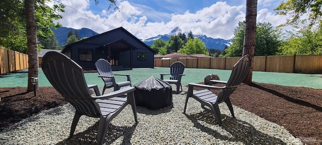 404 Trail St, Darrington, WA 98241 - fenced backyard with an outdoor fire pit and a mountain view