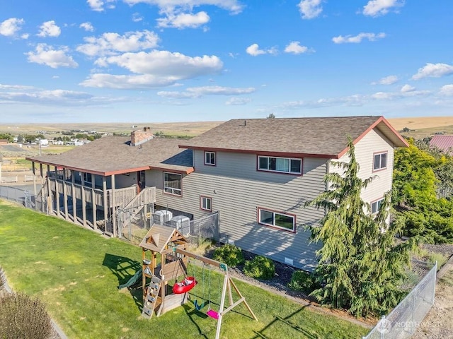 2 W Johnson Ln, Lind, WA 99341 - back of house with a playground, a lawn, and a shingled roof