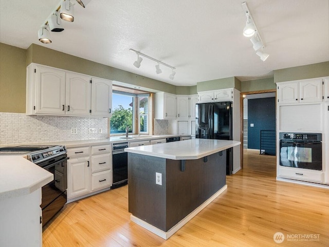 2 W Johnson Ln, Lind, WA 99341 - kitchen with track lighting, black appliances, and white cabinets