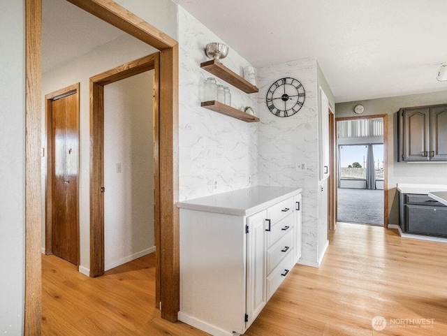 2 W Johnson Ln, Lind, WA 99341 - kitchen featuring light wood-style floors, light countertops, open shelves, and white cabinets